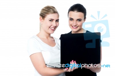 Smiling Caucasian Girls Using Laptop Stock Photo