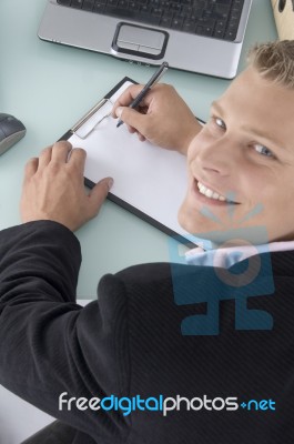 Smiling Ceo Writing on clipboard Stock Photo