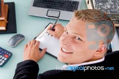 Smiling Ceo Writing on clipboard Stock Photo