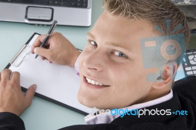 Smiling Ceo Writing on clipboard Stock Photo