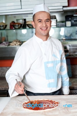 Smiling Chef Making Pizza Stock Photo