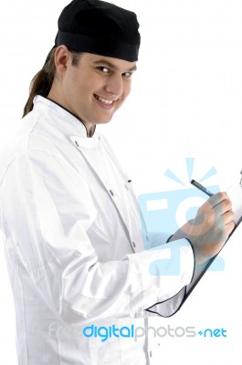 Smiling Chef Writing Stock Photo