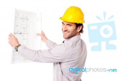 Smiling Construction Engineer Reviewing Blueprint Stock Photo