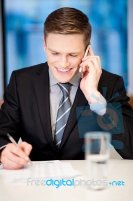 Smiling Corporate Guy Attending Phone Call Stock Photo