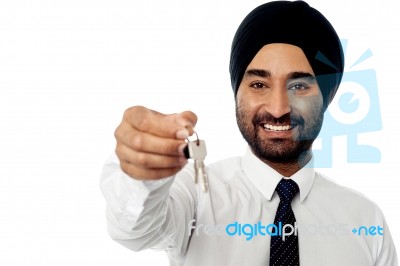 Smiling Corporate Guy Holding A Key Stock Photo