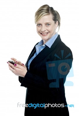 Smiling Corporate Lady Using Cellphone Stock Photo