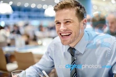 Smiling Corporate Man At Restaurant Stock Photo