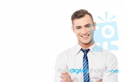 Smiling Corporate Man With Folded Arms Stock Photo