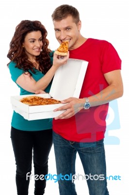 Smiling Couple Eating Pizza Stock Photo