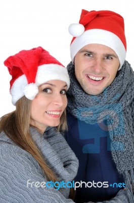 Smiling Couple In Santa Claus Hats Stock Photo