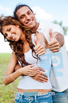 Smiling Couple Showing Thumbs Up Stock Photo