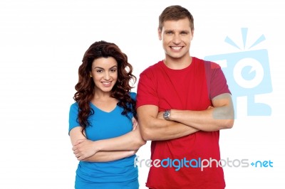 Smiling Couple With Arms Crossed Stock Photo