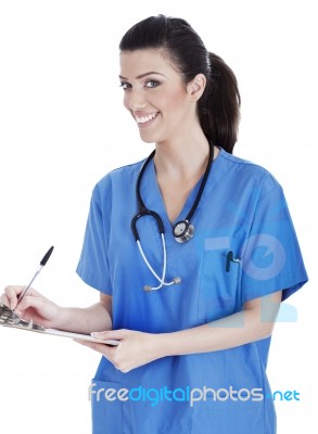 Smiling Cute Nurse Making Her Medical Notes Stock Photo