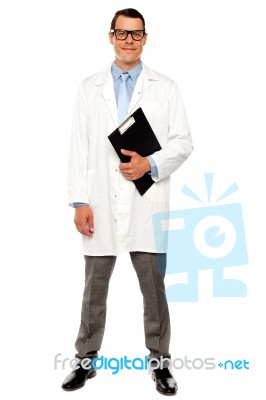 Smiling Doctor Holding Clipboard Stock Photo