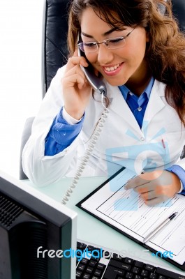 Smiling Doctor Talking On Phone Stock Photo