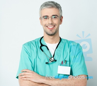 Smiling Doctor With His Arms Crossed Stock Photo