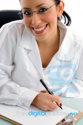 Smiling Doctor Writing Prescription Stock Photo