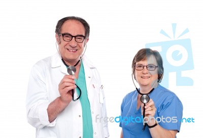 Smiling Doctors Holding Stethoscope Stock Photo