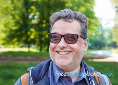 Smiling Elderly Man In Park Stock Photo