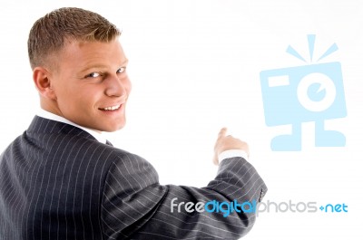 Smiling Employee Pointing Back Stock Photo