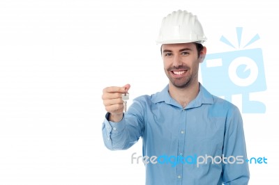 Smiling Engineer Holding Key Stock Photo