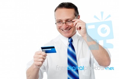 Smiling Executive Holding Credit Card Stock Photo