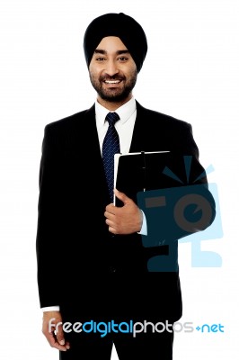 Smiling Executive Holding Notebook Stock Photo