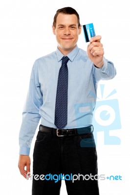 Smiling Executive Showing Credit Card Stock Photo