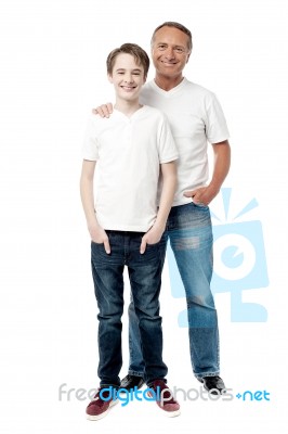 Smiling Father And Son Posting Together Stock Photo