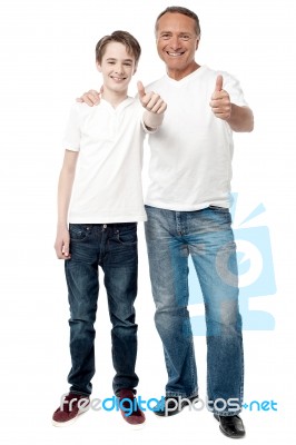 Smiling Father And Son Showing Thumps Up Stock Photo