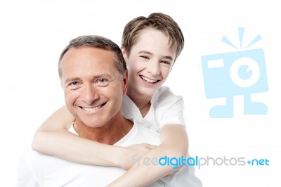 Smiling Father Holding Son On His Shoulders Stock Photo