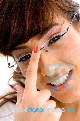 Smiling Female Adjusting Specs Stock Photo