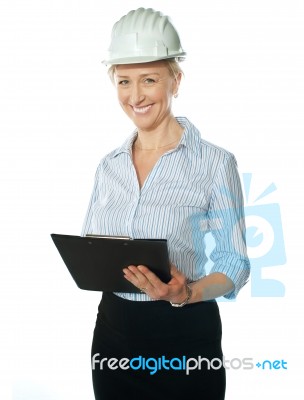 Smiling Female Architect Holding Documents Stock Photo