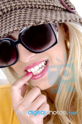 Smiling Female Biting Nail Stock Photo