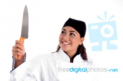 Smiling Female Chef Holding Knife Stock Photo