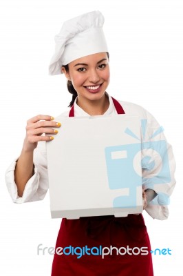 Smiling Female Chef Opening Pizza Box Stock Photo