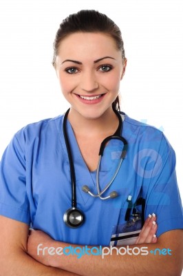 Smiling Female Doctor With Arms Crossed Stock Photo