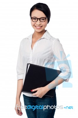 Smiling Female Executive Holding Business Files Stock Photo