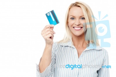 Smiling Female Model Holding Up Credit Card Stock Photo