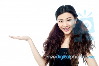 Smiling Female Model Presenting Something Stock Photo