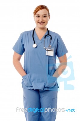 Smiling Female Nurse Standing With Stethoscope Stock Photo