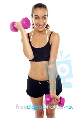 Smiling Fit Woman Working Out With Dumbbells Stock Photo