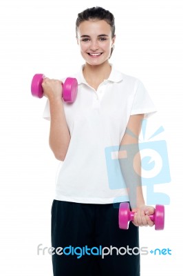 Smiling Fitness Teenage Girl Lifting Weights Stock Photo