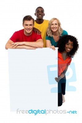 Smiling friends holding blank board Stock Photo