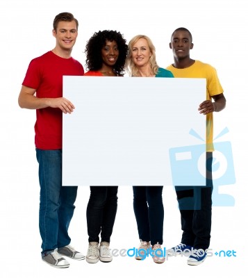 Smiling friends holding blank board Stock Photo