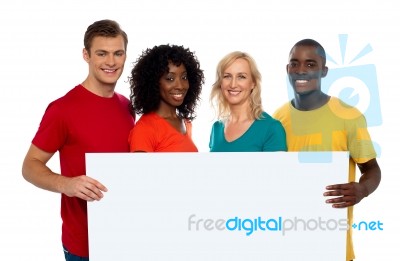 Smiling friends holding blank board Stock Photo