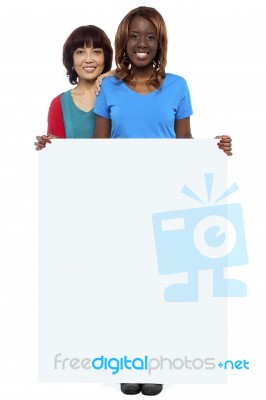 Smiling Friends Holding Blank Board Stock Photo