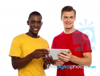 Smiling Friends Using Tablet Pc Stock Photo