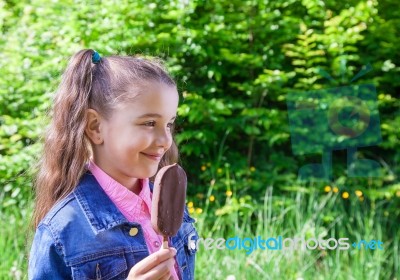 Smiling Girl Eating Ice Cream Stock Photo