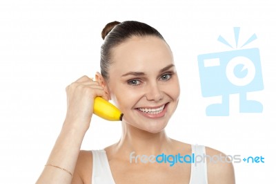 Smiling girl holding banana Stock Photo